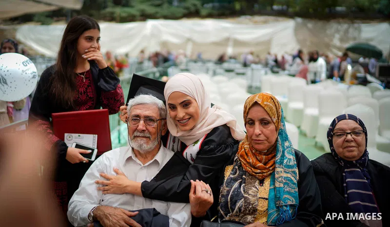 Palestinian students attend their graduation ceremony at Birzeit University in the West Bank city of Ramallah, on June 30, 2021. Photo by Eyad Jadallah