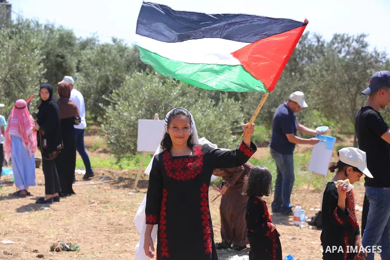 Palestinians take part in an event entitled "The return march is salt of the land and the homeland" near the border fence with Israel, in Maghazi refugee camp in the central Gaza Strip on July 1, 2021. Photo by Ashraf Am...