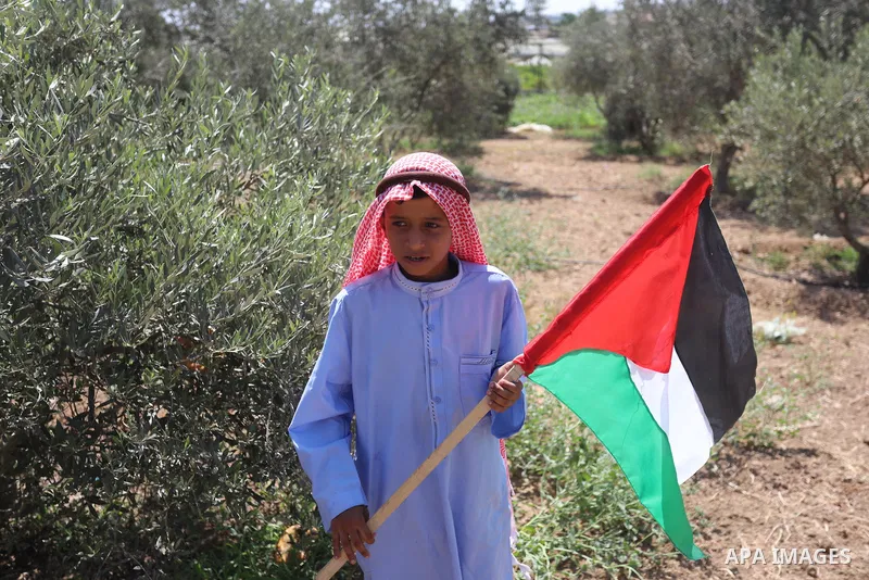 Palestinians take part in an event entitled "The return march is salt of the land and the homeland" near the border fence with Israel, in Maghazi refugee camp in the central Gaza Strip on July 1, 2021. Photo by Ashraf Am...
