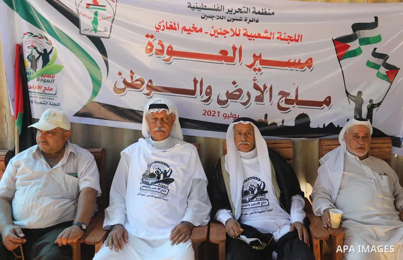 Palestinians take part in an event entitled "The return march is salt of the land and the homeland" near the border fence with Israel, in Maghazi refugee camp in the central Gaza Strip on July 1, 2021. Photo by Ashraf Am...