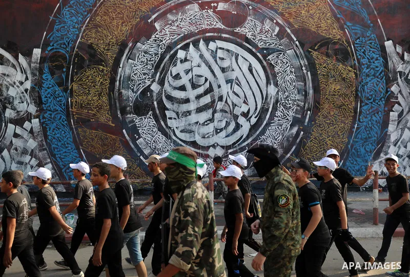 Young Palestinians take part in a graduation ceremony at a military summer camp organised by the Hamas Movement, in Gaza City July 01, 2021. Photo by Ashraf Amra