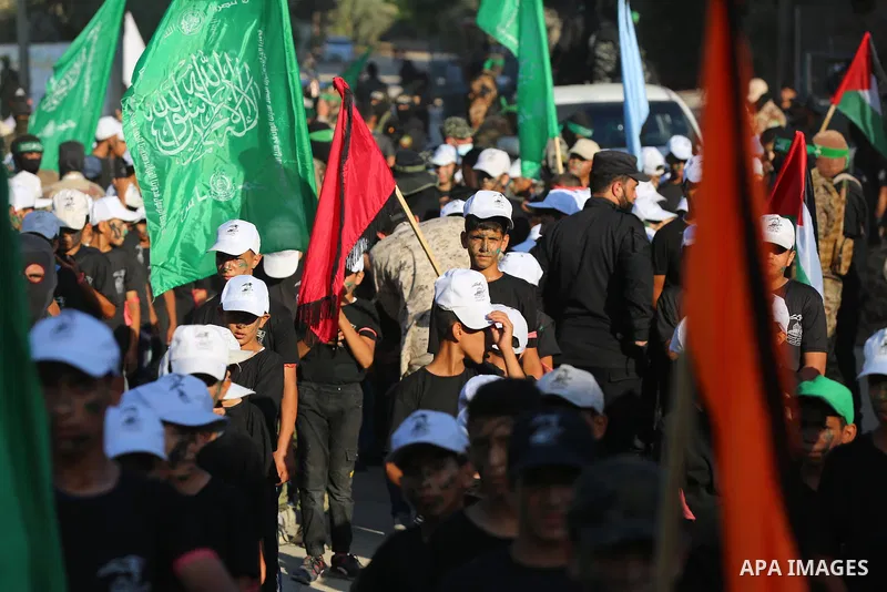 Young Palestinians take part in a graduation ceremony at a military summer camp organised by the Hamas Movement, in Deir al-Balah, in the center of Gaza Strip on July 01, 2021. Photo by Ashraf Amra