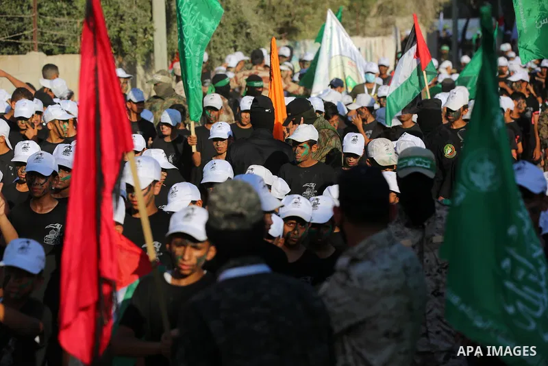 Young Palestinians take part in a graduation ceremony at a military summer camp organised by the Hamas Movement, in Deir al-Balah, in the center of Gaza Strip on July 01, 2021. Photo by Ashraf Amra