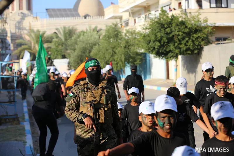 Young Palestinians take part in a graduation ceremony at a military summer camp organised by the Hamas Movement, in Deir al-Balah, in the center of Gaza Strip on July 01, 2021. Photo by Ashraf Amra