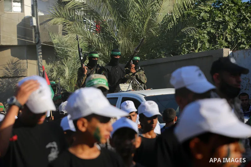 Young Palestinians take part in a graduation ceremony at a military summer camp organised by the Hamas Movement, in Deir al-Balah, in the center of Gaza Strip on July 01, 2021. Photo by Ashraf Amra