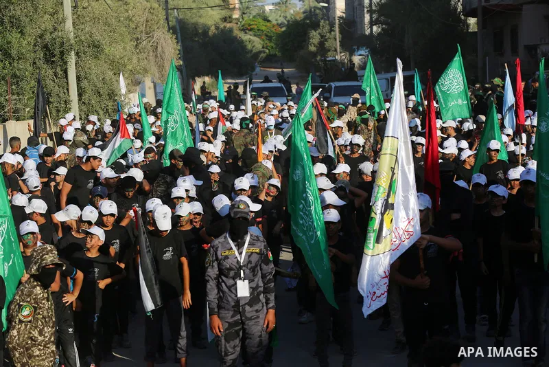 Young Palestinians take part in a graduation ceremony at a military summer camp organised by the Hamas Movement, in Deir al-Balah, in the center of Gaza Strip on July 01, 2021. Photo by Ashraf Amra