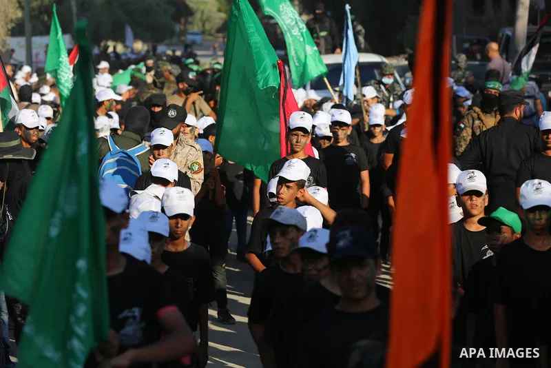 Young Palestinians take part in a graduation ceremony at a military summer camp organised by the Hamas Movement, in Deir al-Balah, in the center of Gaza Strip on July 01, 2021. Photo by Ashraf Amra