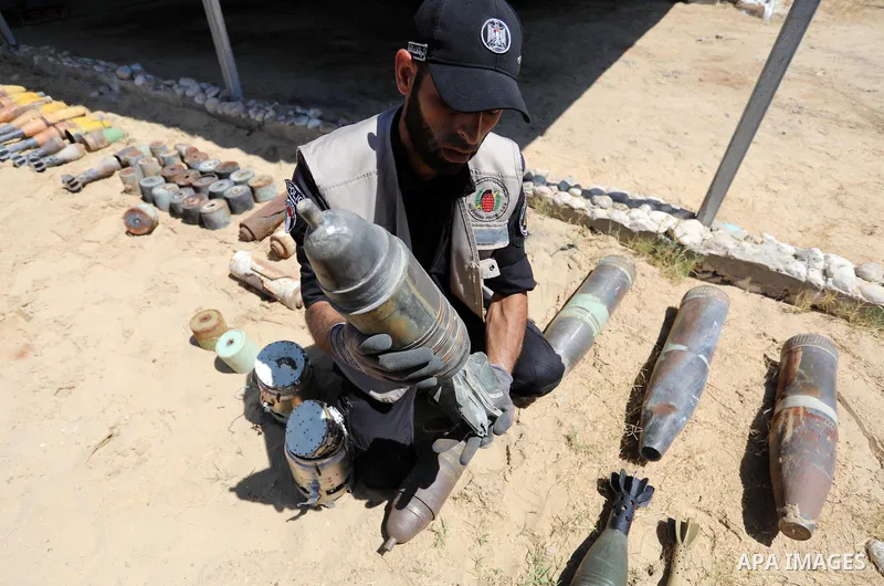 A photo taken on June 5, 2021. show the explosives experts of Hamas retrieve unexploded projectiles from the aftermath of the May 2021 conflict with Israel, from a field in Khan Yunis in the southern Gaza Strip. Gaza’s h...