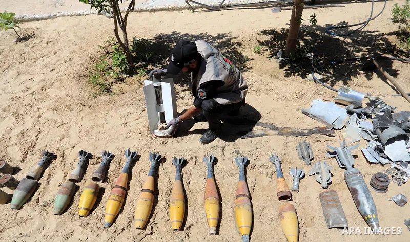 A photo taken on June 5, 2021. show the explosives experts of Hamas retrieve unexploded projectiles from the aftermath of the May 2021 conflict with Israel, from a field in Khan Yunis in the southern Gaza Strip. Gaza’s h...