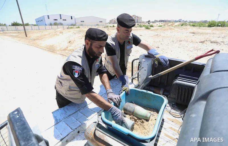 A photo taken on June 5, 2021. show the explosives experts of Hamas retrieve unexploded projectiles from the aftermath of the May 2021 conflict with Israel, from a field in Khan Yunis in the southern Gaza Strip. Gaza’s h...