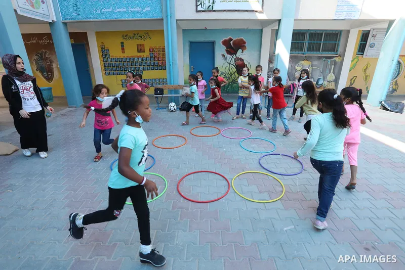 Palestinian schoolgirls enjoy as part of the activities proposed during a summer camp by run by the United Nations Relief and Works Agency (UNRWA) at Nuseirat refugee camp, in the center of Gaza Strip on July 04, 2021. T...