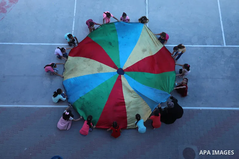 Palestinian schoolgirls enjoy as part of the activities proposed during a summer camp by run by the United Nations Relief and Works Agency (UNRWA) at Nuseirat refugee camp, in the center of Gaza Strip on July 04, 2021. T...