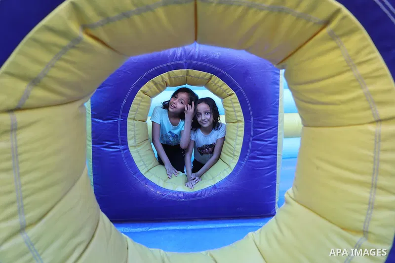 Palestinian schoolgirls enjoy as part of the activities proposed during a summer camp by run by the United Nations Relief and Works Agency (UNRWA) at Nuseirat refugee camp, in the center of Gaza Strip on July 04, 2021. T...