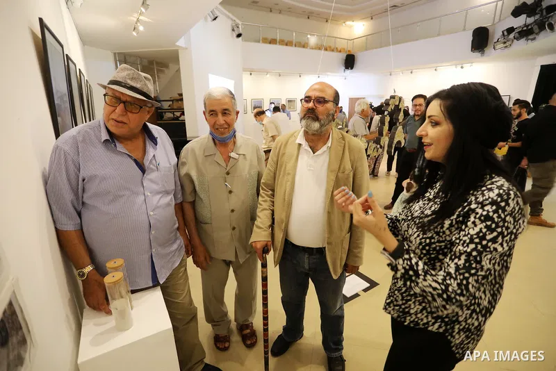 Palestinians attend an exhibition of photos and sculptures "Scenes from Palestine" by artist Rana El-Batrawi in Gaza City, on July 05, 2021. Photo by Ashraf Amra