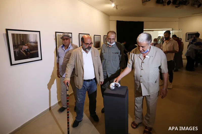Palestinians attend an exhibition of photos and sculptures "Scenes from Palestine" by artist Rana El-Batrawi in Gaza City, on July 05, 2021. Photo by Ashraf Amra