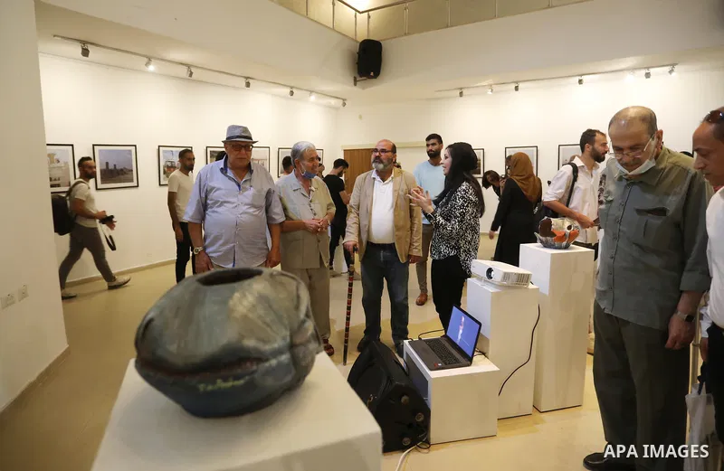 Palestinians attend an exhibition of photos and sculptures "Scenes from Palestine" by artist Rana El-Batrawi in Gaza City, on July 05, 2021. Photo by Ashraf Amra