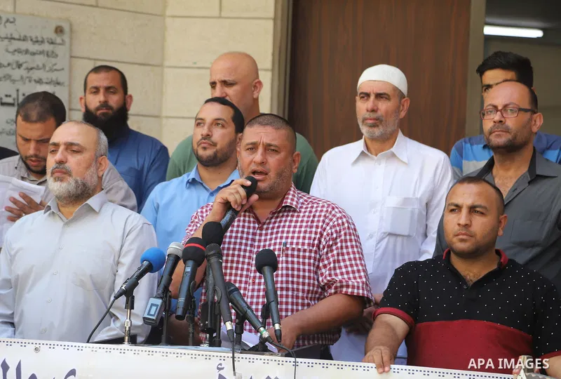Palestinians hold placards during a protest in solidarity with prisoner in Israeli jails Ghadanfar Abu Atwan, in Gaza city on July 6, 2021. Palestinian prisoner in Israeli jails, Ghadanfar Abu Atwan, continues his hunger...