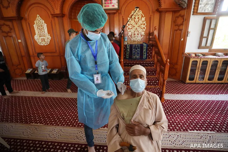 A Palestinian man receives a dose of Russia's Sputnik V COVID-19 coronavirus vaccine at a mosque in Khan Yunis town in the southern Gaza Strip, on July 8, 2021. Regarding the Covid-19 vaccination rollout, Alkaila said th...