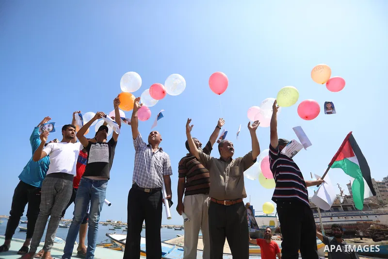 Palestinian fishermen take part in a protest against Israeli naval attack on their colleagues and their rights at Gaza seaport on July 11 2021. Head of Fishermen Syndicate, Nizar Ayyash, said: "We are standing today to e...