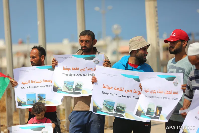 Palestinian fishermen take part in a protest against Israeli naval attack on their colleagues and their rights at Gaza seaport on July 11 2021. Head of Fishermen Syndicate, Nizar Ayyash, said: "We are standing today to e...