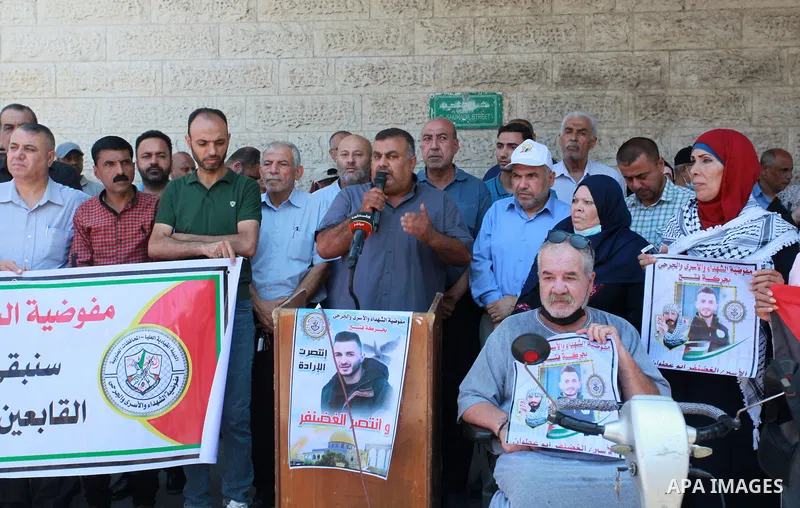 Palestinians take part in a celebration of Ghazanfar Abu Atwan who was released from Israeli Jails, in front of Red Cross office, in Gaza city on July 11 2021. Palestinian prisoner Ghazanfar Abu Atwan has suspended his h...