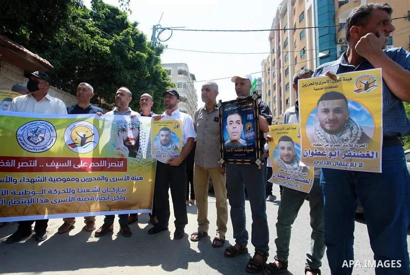 Palestinians take part in a celebration of Ghazanfar Abu Atwan who was released from Israeli Jails, in front of Red Cross office, in Gaza city on July 11 2021. Palestinian prisoner Ghazanfar Abu Atwan has suspended his h...