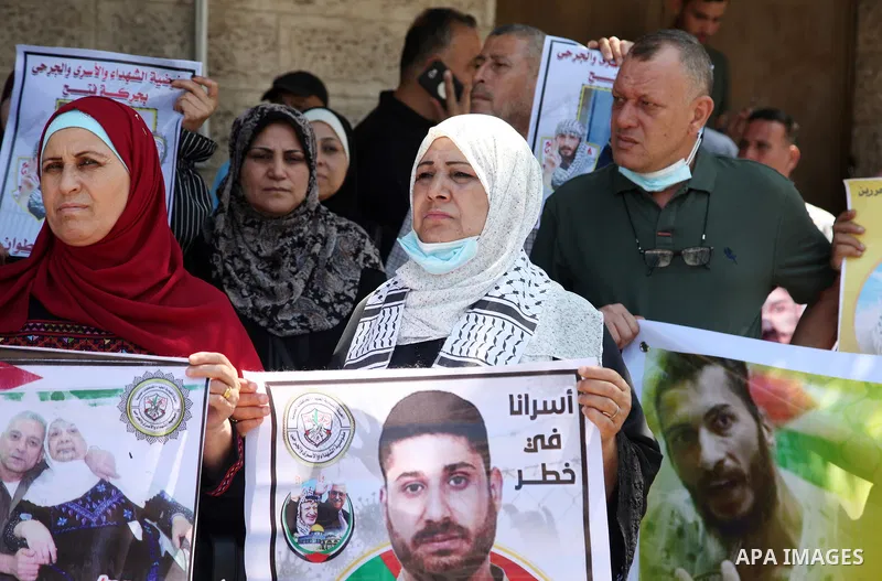 Palestinians take part in a celebration of Ghazanfar Abu Atwan who was released from Israeli Jails, in front of Red Cross office, in Gaza city on July 11 2021. Palestinian prisoner Ghazanfar Abu Atwan has suspended his h...