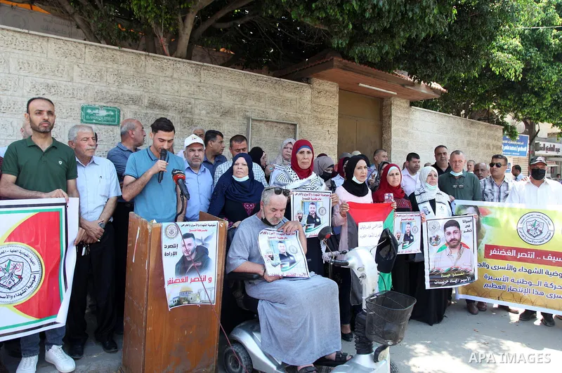 Palestinians take part in a celebration of Ghazanfar Abu Atwan who was released from Israeli Jails, in front of Red Cross office, in Gaza city on July 11 2021. Palestinian prisoner Ghazanfar Abu Atwan has suspended his h...