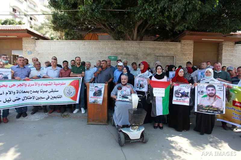 Palestinians take part in a celebration of Ghazanfar Abu Atwan who was released from Israeli Jails, in front of Red Cross office, in Gaza city on July 11 2021. Palestinian prisoner Ghazanfar Abu Atwan has suspended his h...
