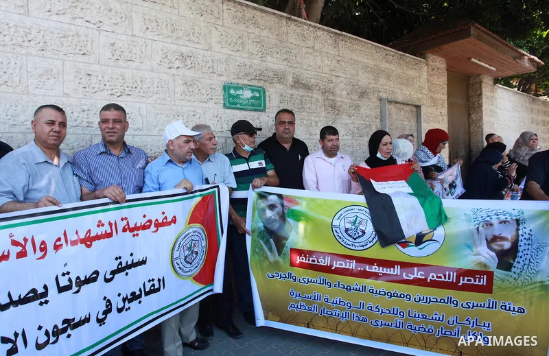 Palestinians take part in a celebration of Ghazanfar Abu Atwan who was released from Israeli Jails, in front of Red Cross office, in Gaza city on July 11 2021. Palestinian prisoner Ghazanfar Abu Atwan has suspended his h...