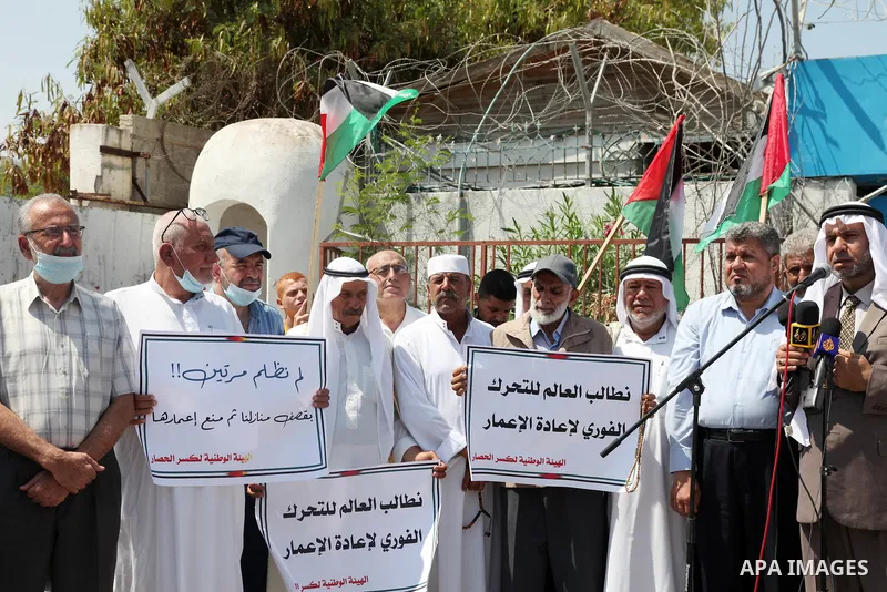 Palestinian clans take part in a protest to demand the opening of the crossings and reconstruction and the entry of building materials, in front of the headquarter United Nation "UNSCO" in Gaza city, on July 11 2021. Pho...