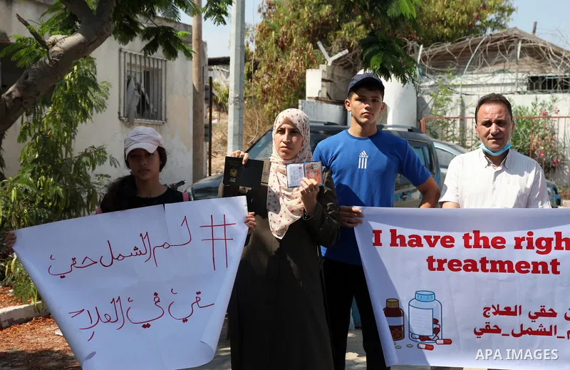 Palestinians hold IDs and banners to demand of the family unification, in front of the headquarter United Nation "UNSCO" in Gaza city, on July 11 2021. Israeli laws and policies prevent the reunification of families betw...