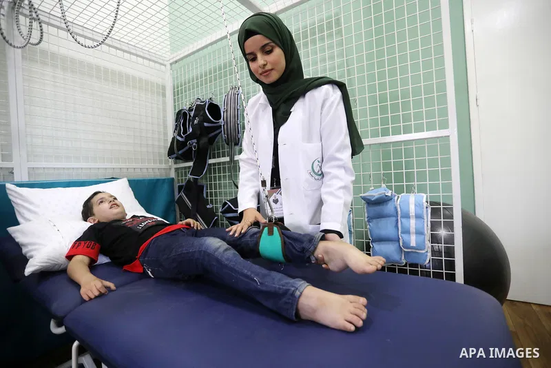 Palestinian children with disabilities practice different activities during a summer camp, in Deir al-Balah in the center in the Gaza Strip on July 11, 2021. Almost 50,000 Palestinians are classified as "disabled" among...