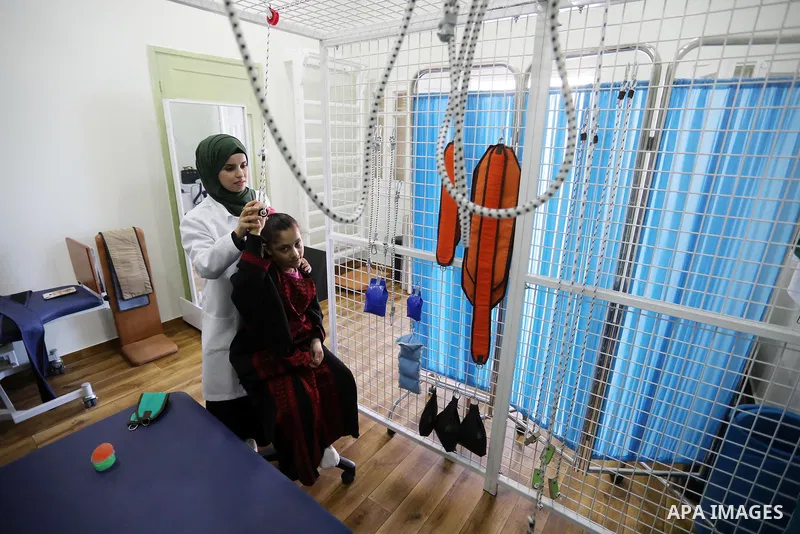 Palestinian children with disabilities practice different activities during a summer camp, in Deir al-Balah in the center in the Gaza Strip on July 11, 2021. Almost 50,000 Palestinians are classified as "disabled" among...