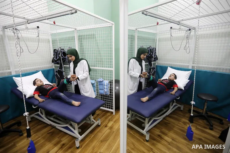 Palestinian children with disabilities practice different activities during a summer camp, in Deir al-Balah in the center in the Gaza Strip on July 11, 2021. Almost 50,000 Palestinians are classified as "disabled" among...