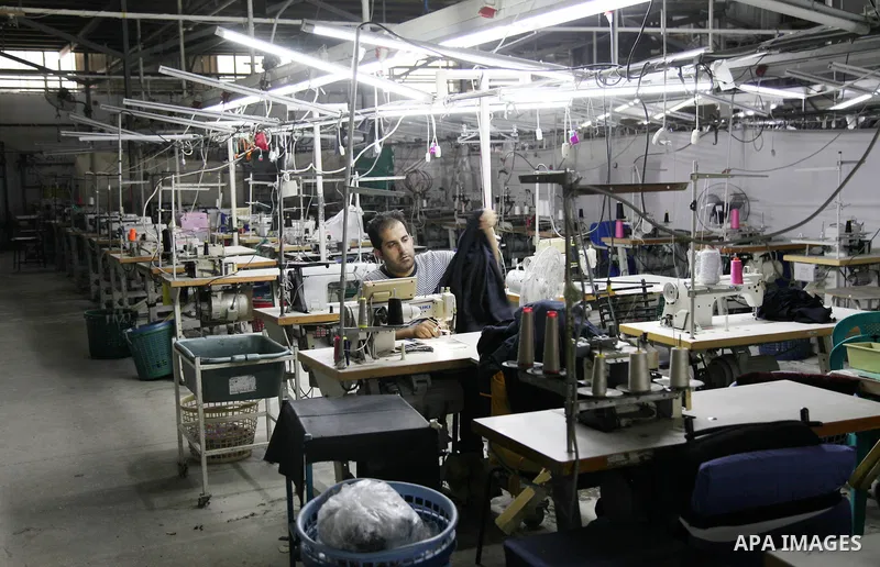 Palestinian labourers work inside clothing factory (UniPal 2000) at the Karni industrial area, east of Gaza city on July 11, 2021. Before 2007, Israeli clothing merchants and businessmen used to send raw material to Gaza...