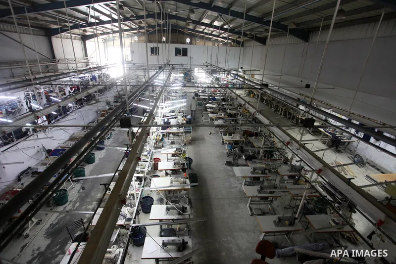 Palestinian labourers work inside clothing factory (UniPal 2000) at the Karni industrial area, east of Gaza city on July 11, 2021. Before 2007, Israeli clothing merchants and businessmen used to send raw material to Gaza...
