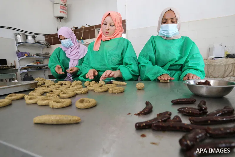 Palestinian women prepare traditional date-filled mini cakes, ahead of Eid al-Adha, in Beit Lahia in the northern of Gaza Strip, on July 18, 2021. Eid al-Adha, or the feast of sacrifice, falls at this month when Muslims...