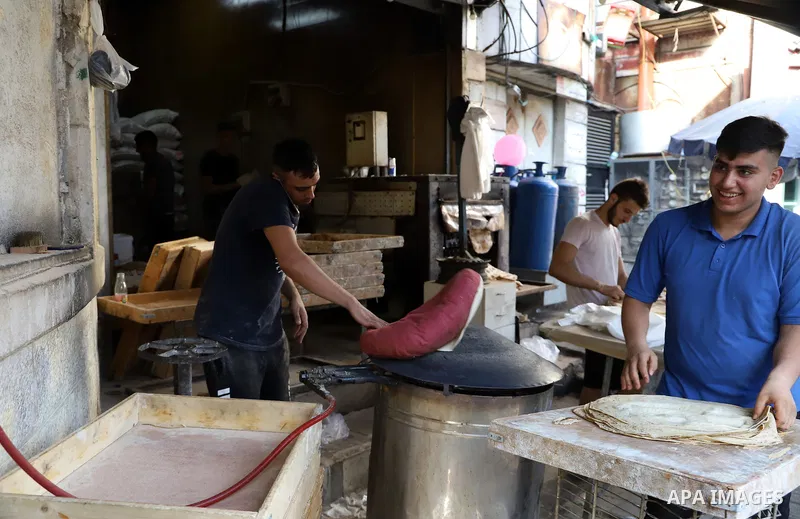 Palestinians shop at markets a day before Eid al-Adha, in the West Bank city of Ramallah on July 19, 2021. Eid al-Adha, or Feast of Sacrifice, Islam's most important holiday marks the willingness of the Prophet Ibrahim t...