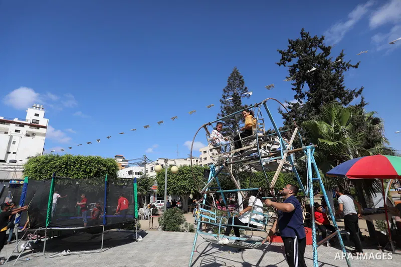 Palestinian children play at a park during the second day of Eid al-Adha festival celebrated by Muslims worldwide, in Gaza City on July 21, 2021. The al-Adha, or "Feast of Sacrifice", marks the end of the annual pilgrima...