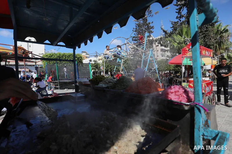 Palestinian children play at a park during the second day of Eid al-Adha festival celebrated by Muslims worldwide, in Gaza City on July 21, 2021. The al-Adha, or "Feast of Sacrifice", marks the end of the annual pilgrima...
