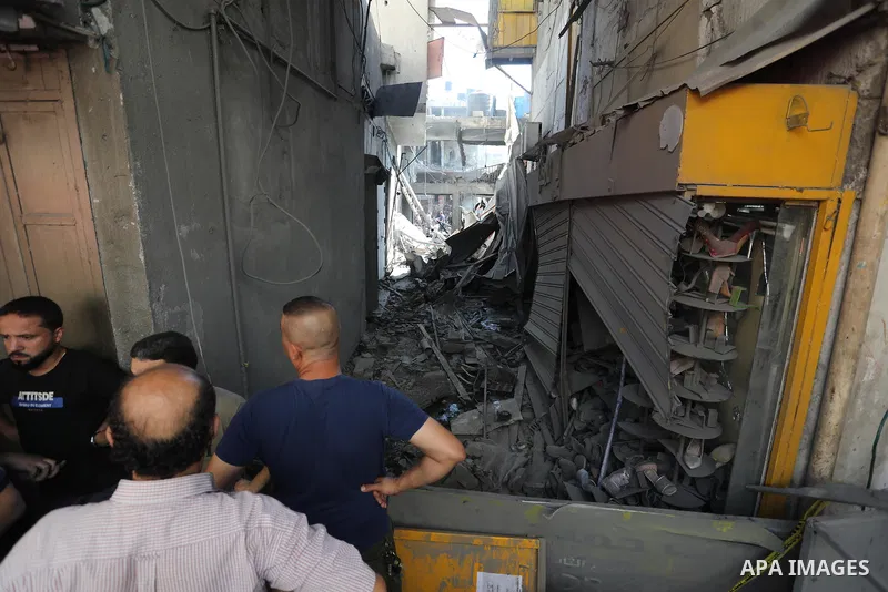 Palestinians gather at the scene of a blast in Gaza City, the cause of which has not yet been determined, on July 22, 2021. Photo by Ashraf Amra
