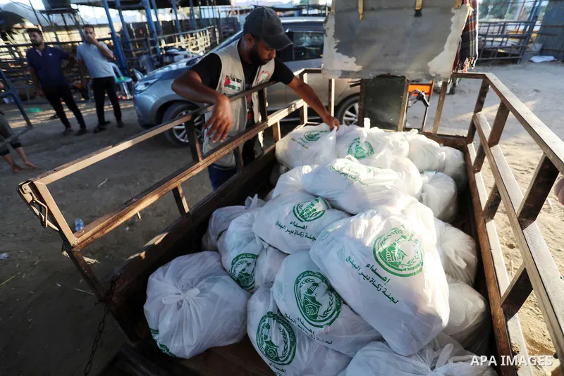 Palestinian volunteers prepare freshly slaughtered livestock to distribute to the poor after a sacrifice ritual at a slaughterhouse during the Eid al-Adha festival, in Deir al-Balah in the center of Gaza Strip on July 23...