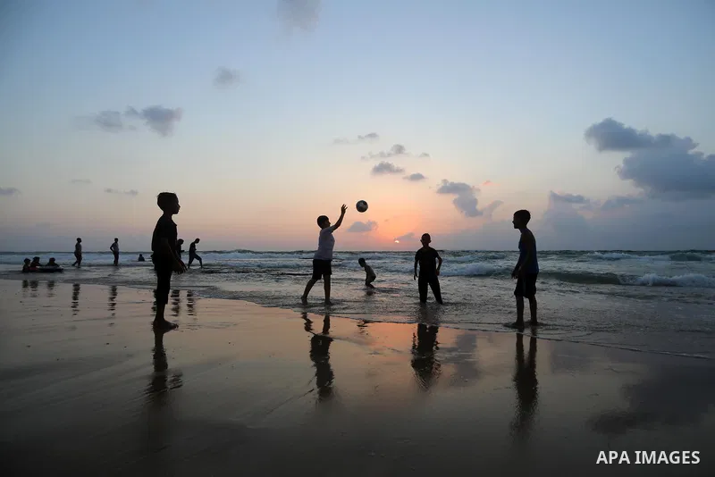 Palestinians enjoy the beach of the Mediterranean sea in Deir al-Balah in the center of Gaza Strip, during the fourth day of Eid al-adha festival on July 23, 2021. The al-Adha, or "Feast of Sacrifice", marks the end of t...
