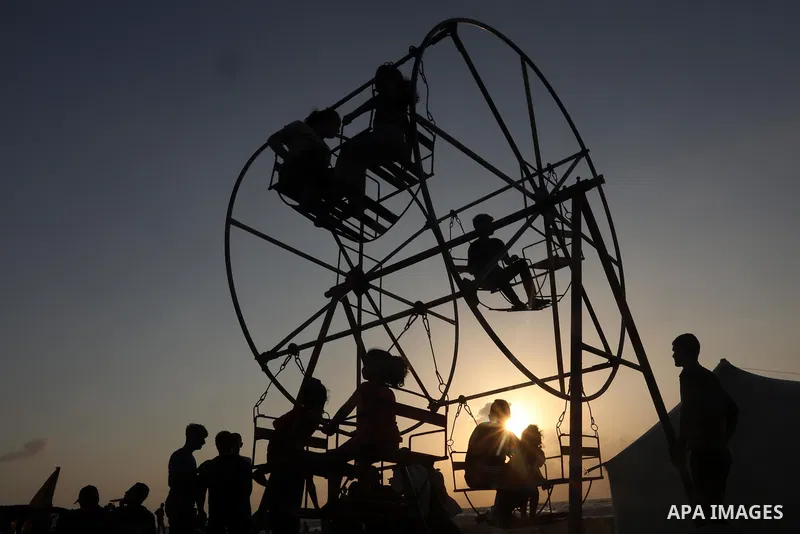 Palestinians enjoy the beach of the Mediterranean sea in Deir al-Balah in the center of Gaza Strip, during the fourth day of Eid al-adha festival on July 23, 2021. The al-Adha, or "Feast of Sacrifice", marks the end of t...