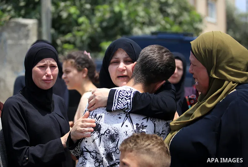 Palestinian relatives of Muhammad al-Tamimi mourn during his funeral in Deir Nizam, west of Ramallah city in the occupied West Bank, on July 24, 2021. Al-Tamimi has died after being shot during clashes with Israeli soldi...