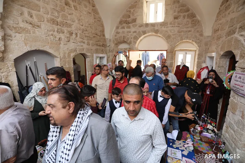 Palestinians attend an exhibition entitled "Our Heritage, Our Identity" marking the Palestinian traditional customs day, in Gaza City, on July 25, 2021. Palestinian costumes are the traditional clothing worn by Palestini...