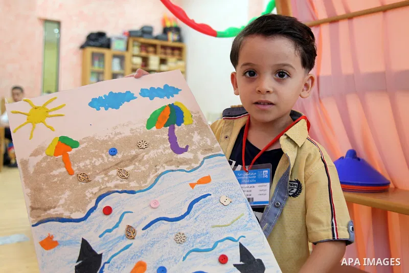 Palestinian children and their mothers participate in an awareness activity related to some correct concepts at Qattan Foundation in Gaza city on July 28, 2021. With schools shuttered due to coronavirus and the summer hi...