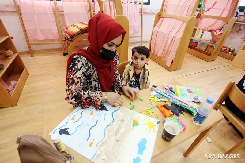 Palestinian children and their mothers participate in an awareness activity related to some correct concepts at Qattan Foundation in Gaza city on July 28, 2021. With schools shuttered due to coronavirus and the summer hi...