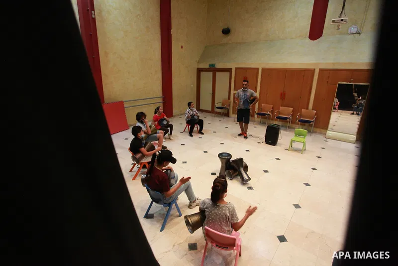 Palestinian children attend a class to learn Darbuka (goblet drum) at Qattan Foundation in Gaza city on July 29, 2021. With schools shuttered due to coronavirus and the summer hiatus, Gaza's children have little to keep...